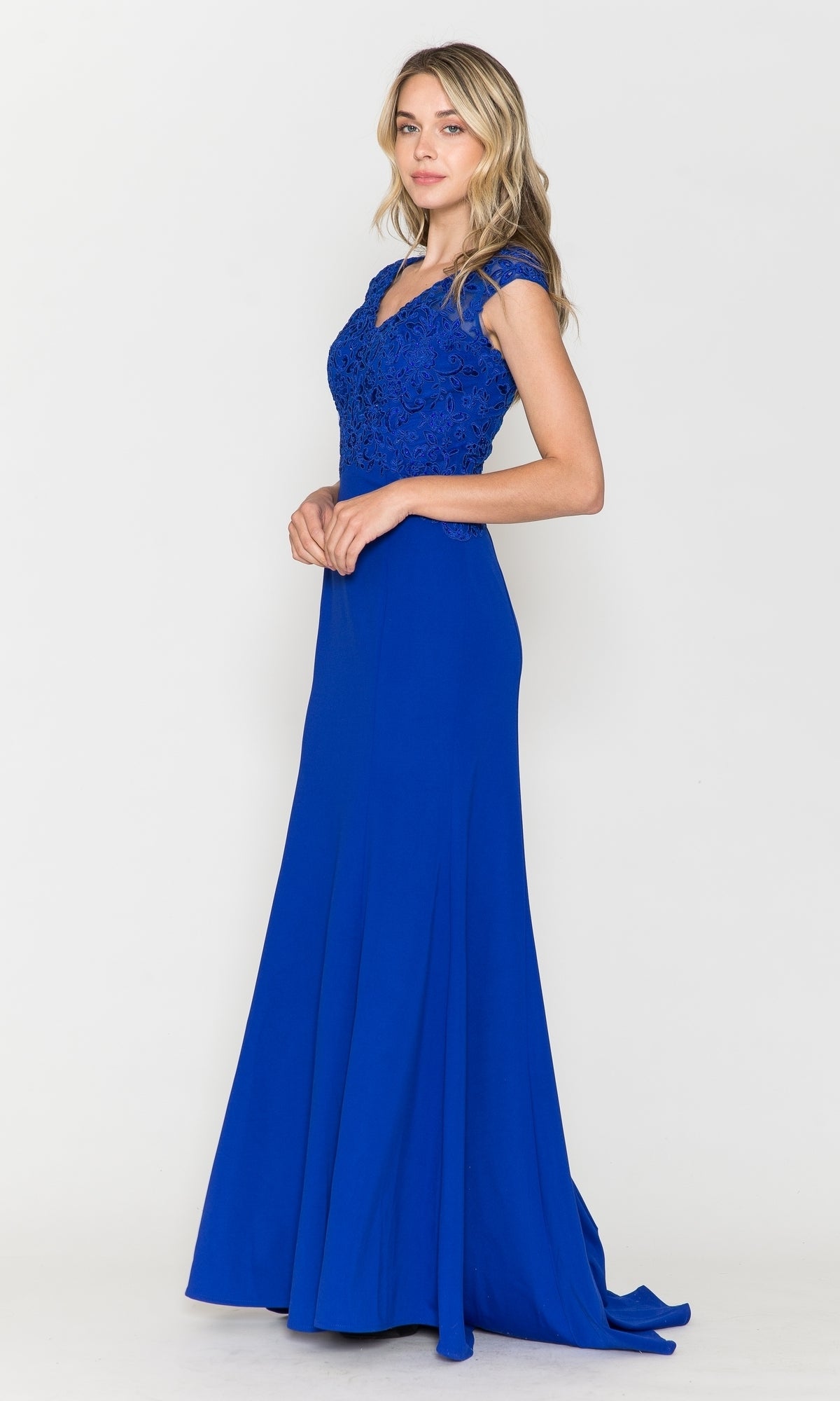 Woman modeling the Cap-Sleeve Embroidered Jersey Long Prom Dress 8558 in royal, featuring cap sleeves and lace embroidery on the bodice, standing against a plain white background.